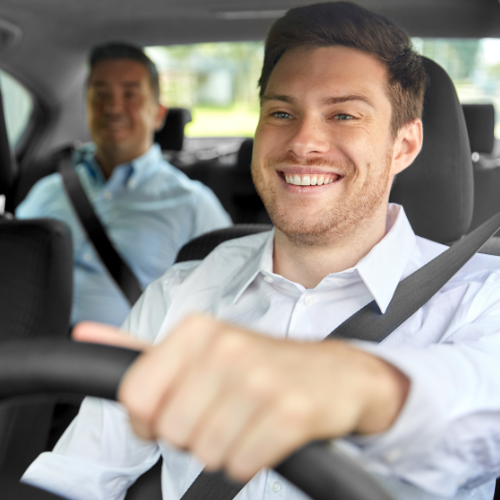 Friendly Private Driver – AlicanteFlyTransfer Service Smiling private driver with a happy passenger during a comfortable ride