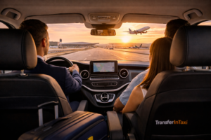 Interior view of a TransferInTaxi vehicle at Alicante Airport with a plane taking off